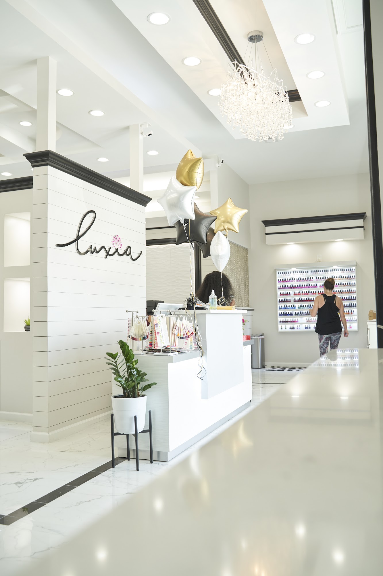 Luxia West Ashley reception with crystal chandeliers and marble interior